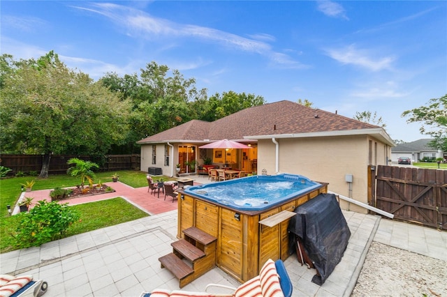 view of swimming pool with a patio area and a hot tub