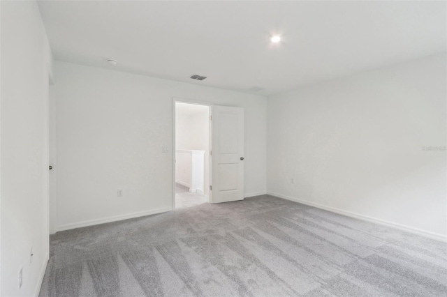 empty room with light colored carpet