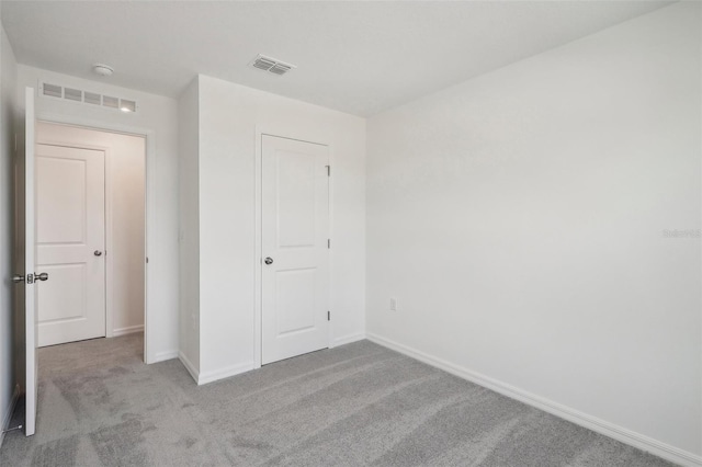 unfurnished bedroom with light colored carpet