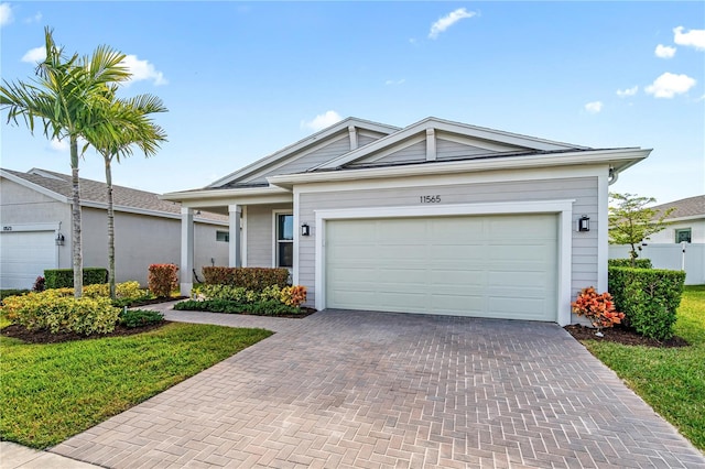 view of front facade featuring a garage and a front lawn