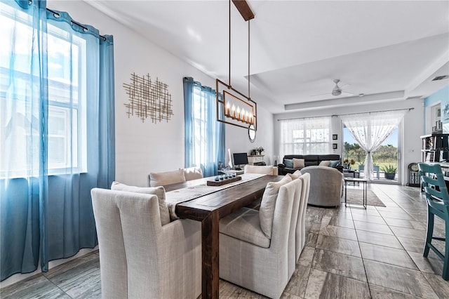 dining area with ceiling fan with notable chandelier