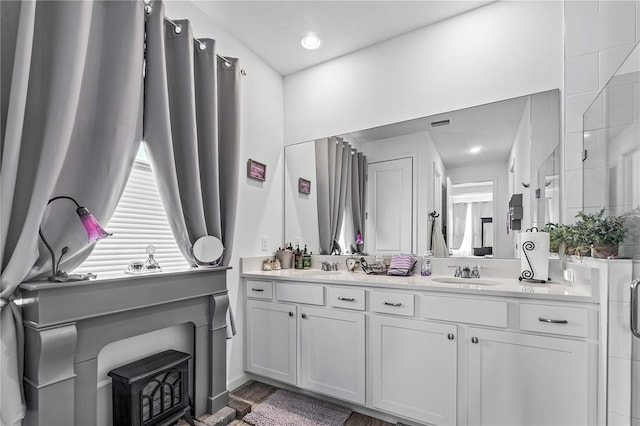 bathroom with vanity, an enclosed shower, and hardwood / wood-style flooring