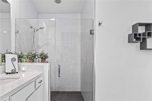 bathroom with vanity and a shower with shower door