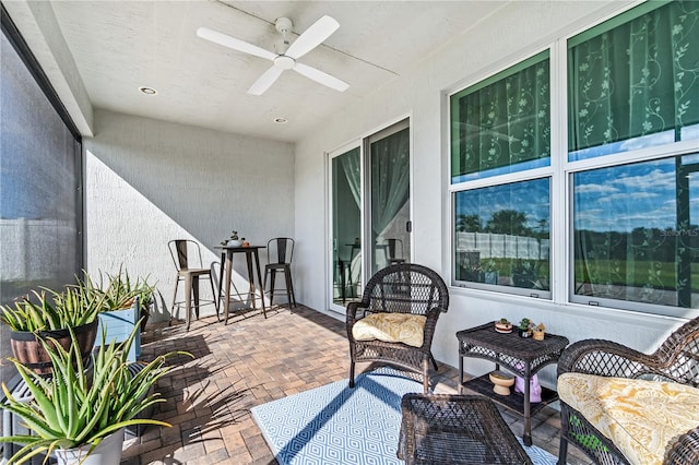 balcony with ceiling fan and a patio