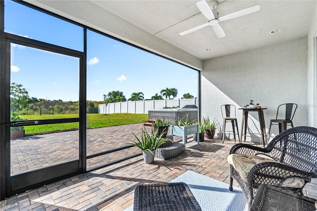 sunroom featuring plenty of natural light and ceiling fan