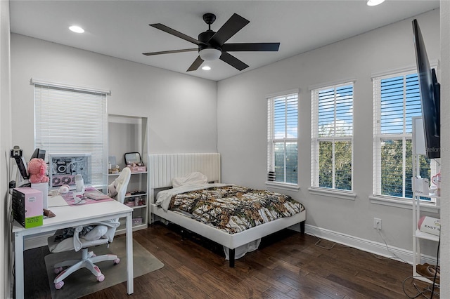 bedroom with dark hardwood / wood-style flooring and ceiling fan