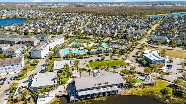 drone / aerial view with a water view and a residential view