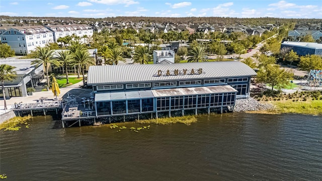 drone / aerial view with a water view and a residential view