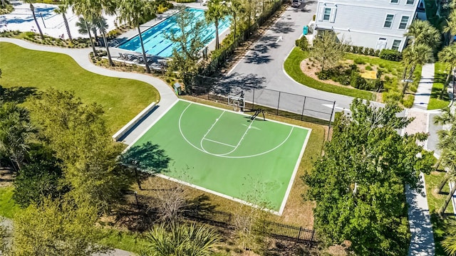 view of sport court featuring community basketball court, a lawn, and fence