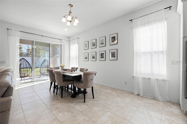 tiled dining space featuring a notable chandelier and plenty of natural light