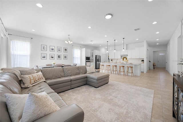 tiled living room with a chandelier