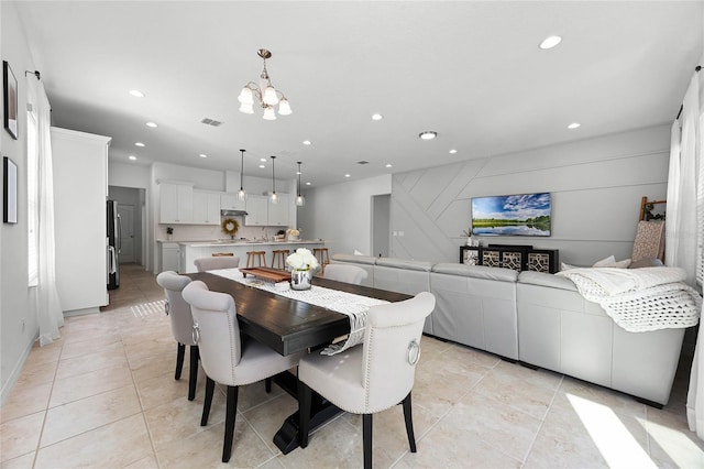 dining room featuring a notable chandelier and light tile patterned floors