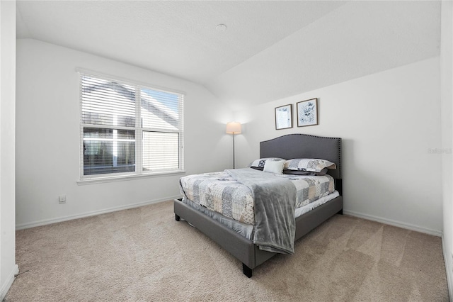 carpeted bedroom with vaulted ceiling