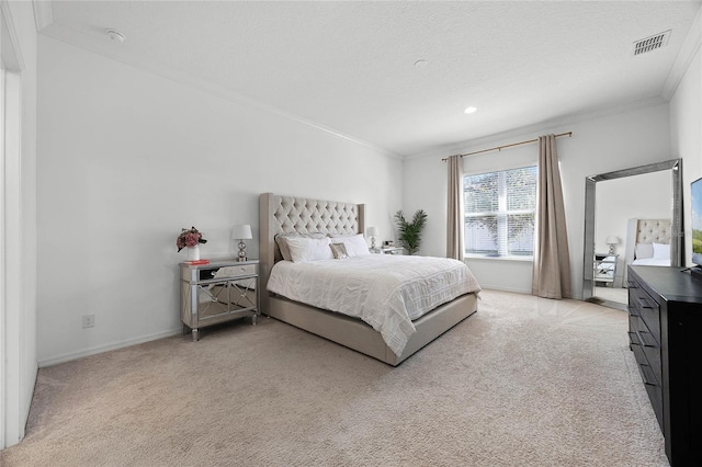 bedroom featuring light carpet, a textured ceiling, and crown molding