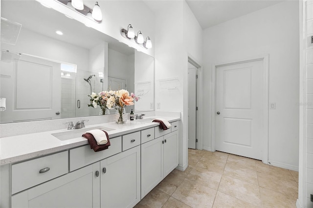 bathroom featuring tile patterned floors, vanity, and walk in shower