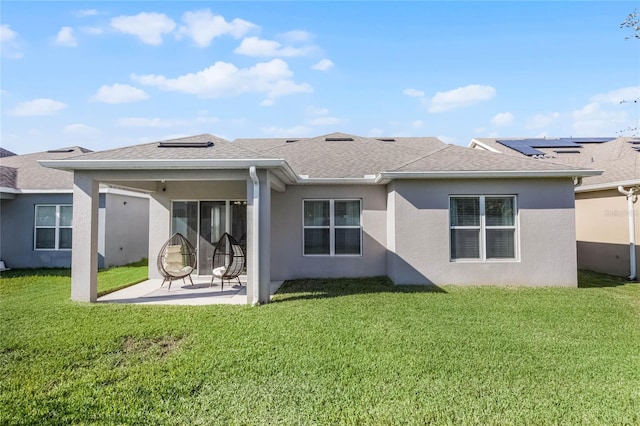 back of house featuring a lawn and a patio