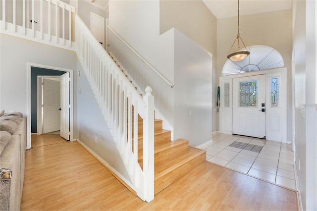 entryway featuring hardwood / wood-style floors and high vaulted ceiling