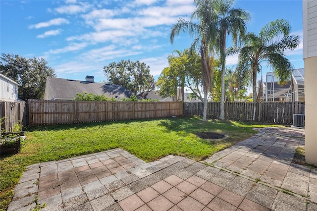 view of yard with central AC unit and a patio