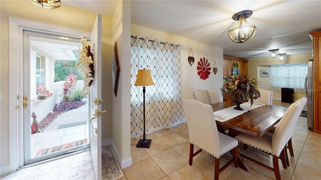 dining room with light tile patterned flooring and a textured ceiling