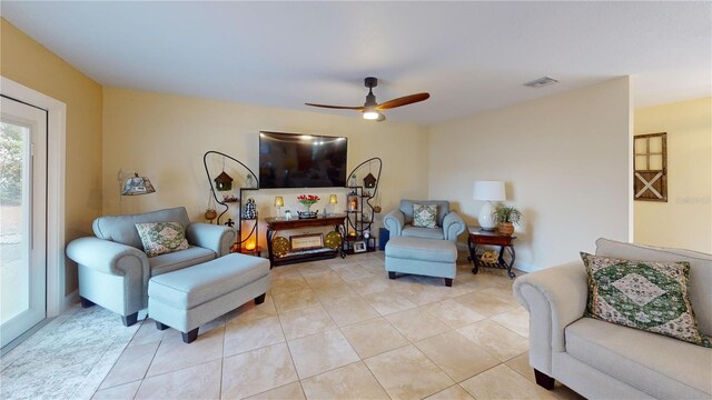 living room with visible vents, ceiling fan, and light tile patterned flooring