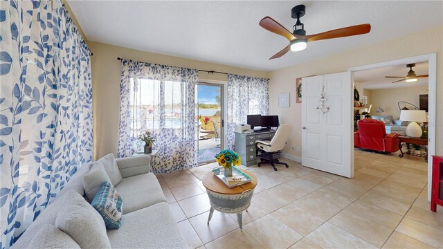 living area with light tile patterned floors and baseboards