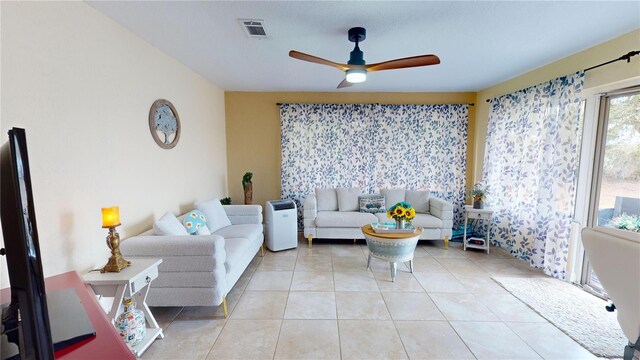 tiled living room with visible vents and a ceiling fan