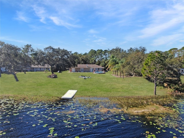 dock area featuring a yard and a water view