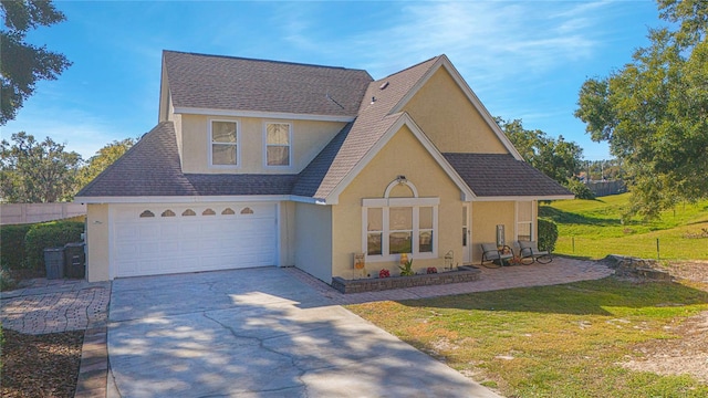 view of front of home featuring a front yard and a garage