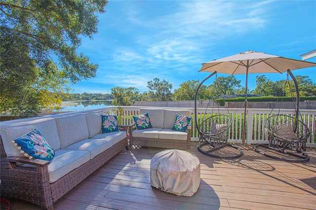 wooden terrace with an outdoor hangout area and a water view