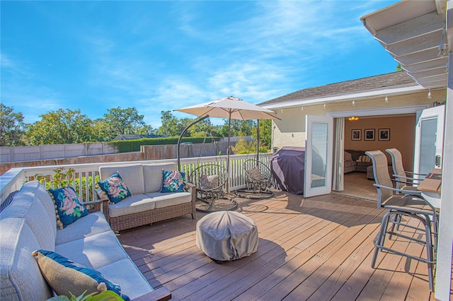 wooden deck with a grill and an outdoor living space