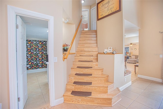 staircase with tile patterned floors and ceiling fan