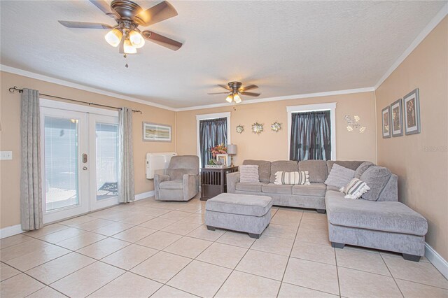 living room featuring french doors, a textured ceiling, ceiling fan, crown molding, and light tile patterned floors