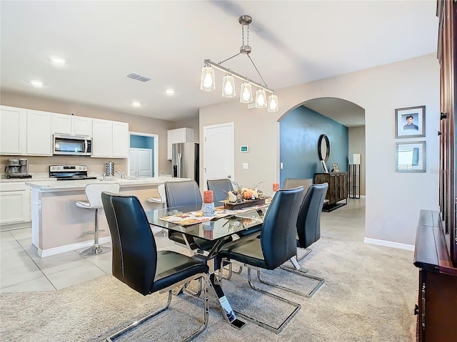 tiled dining space featuring sink