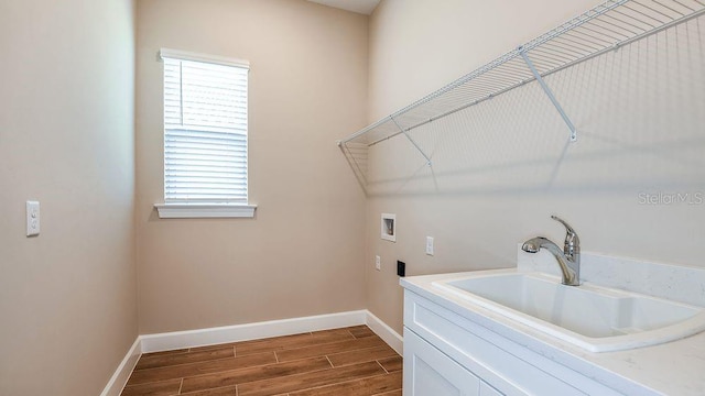 washroom featuring cabinets, hookup for a washing machine, dark hardwood / wood-style floors, and sink