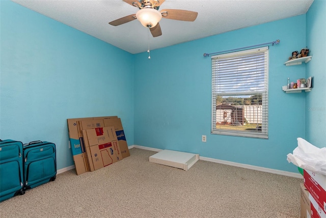 interior space featuring carpet flooring, ceiling fan, and a textured ceiling