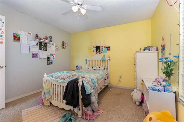 carpeted bedroom with a textured ceiling and ceiling fan