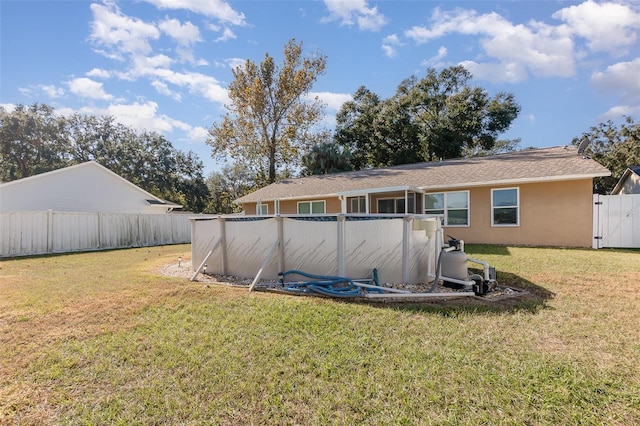 rear view of house with a yard