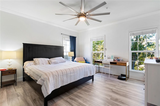 bedroom featuring ceiling fan, light hardwood / wood-style floors, and ornamental molding