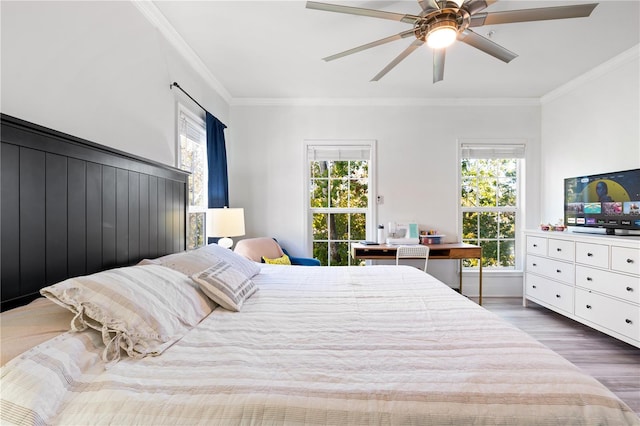 bedroom with crown molding, ceiling fan, and dark wood-type flooring