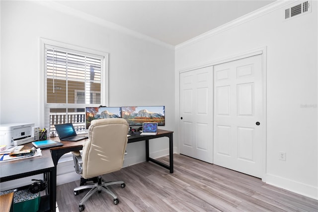 home office featuring crown molding and light hardwood / wood-style flooring