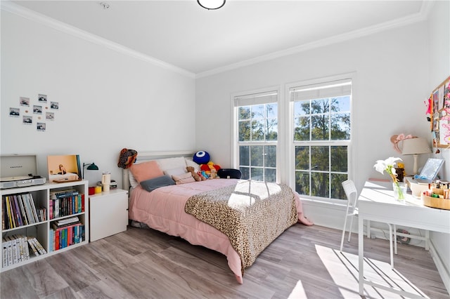 bedroom with hardwood / wood-style flooring and ornamental molding