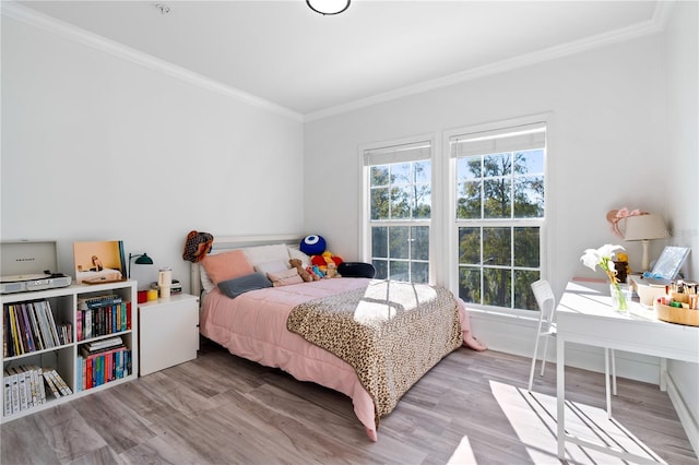 bedroom featuring hardwood / wood-style flooring and crown molding