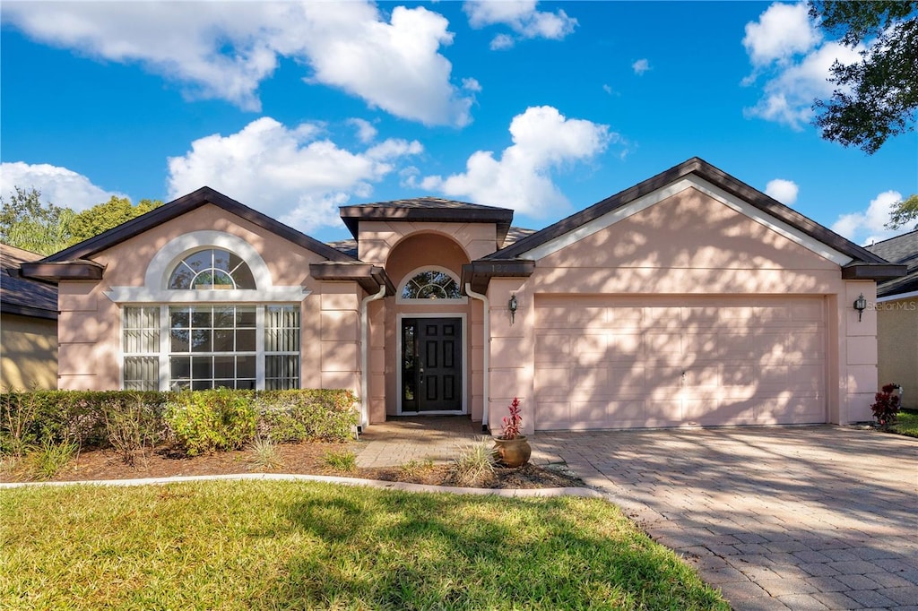 view of front of house with a garage and a front yard