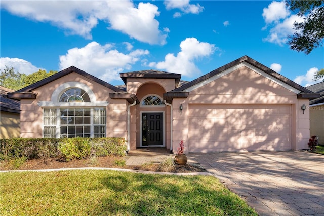 view of front of house with a garage and a front yard