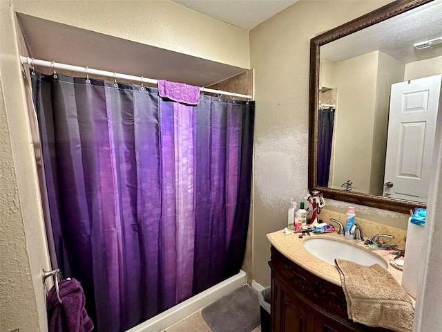 bathroom featuring tile patterned flooring and vanity