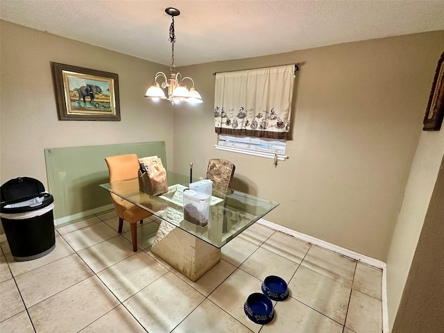 dining area with light tile patterned flooring, a textured ceiling, and an inviting chandelier