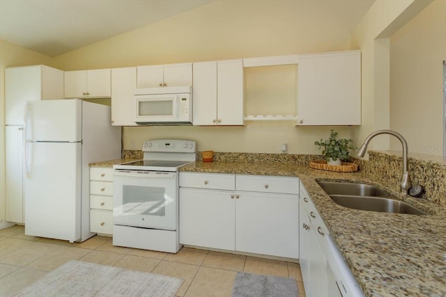 kitchen with light stone counters, white appliances, vaulted ceiling, sink, and white cabinets