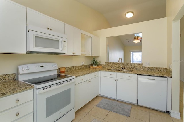 kitchen featuring white cabinetry, sink, vaulted ceiling, white appliances, and light tile patterned floors