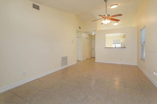 tiled spare room with ceiling fan and lofted ceiling