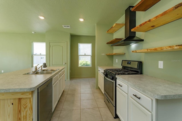 kitchen featuring white cabinetry, a center island with sink, extractor fan, and appliances with stainless steel finishes